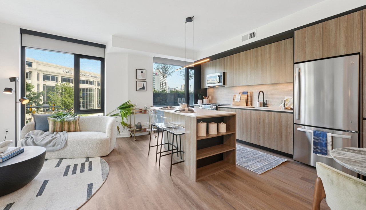 Sunlit model residence interior with open kitchen and living area