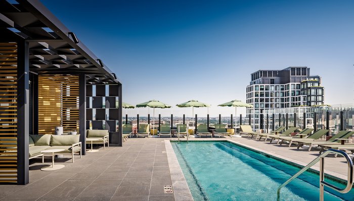 Rooftop pool deck with cabanas and city views